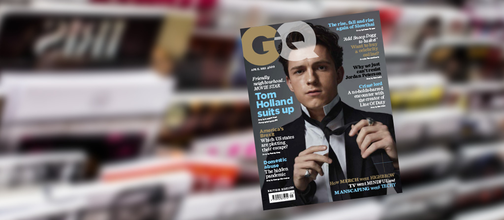 GQ cover in front of magazines